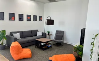 Lounge area with sofas and orange bean bags at the Azendo Bangkok office