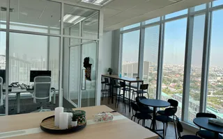 Breakout area at the Bangkok office, with a dartboard and a skyline view