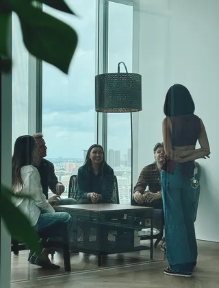 A team meeting in a glass-walled room at the Azendo Bangkok office