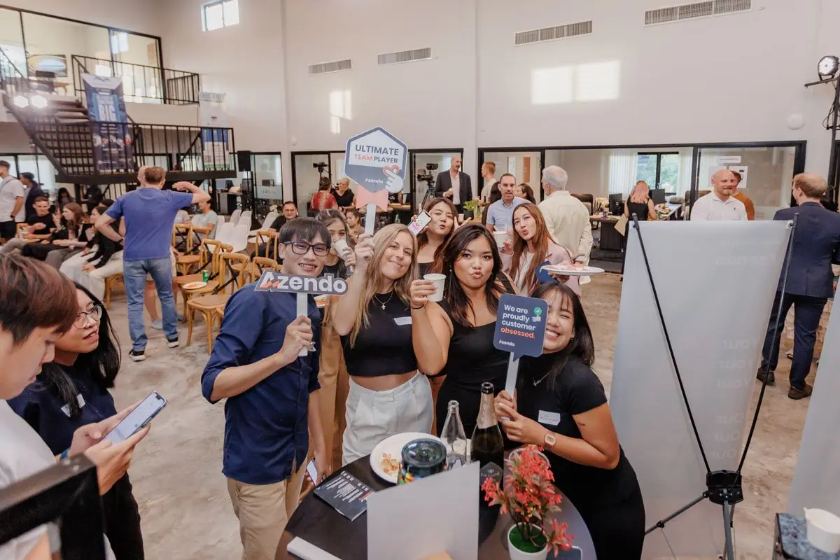 Azendo team members with the values signs at an event in the Chiang Mai hall
