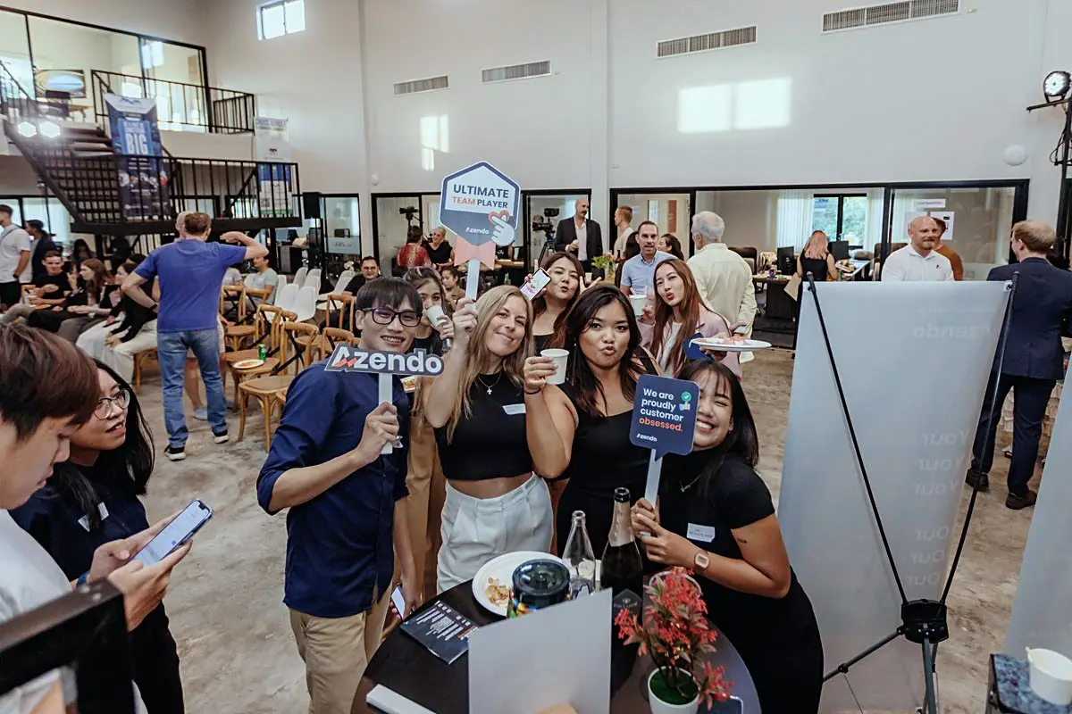 Offshore development team members with Azendo signs at a company event