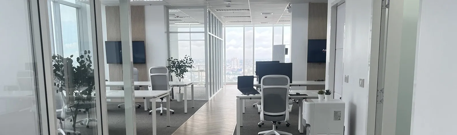 Rows of desks at the Azendo Bangkok office, with the city skyline behind them