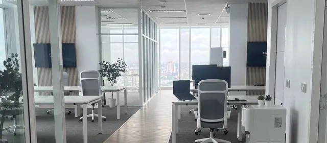 Rows of desks at the Azendo Bangkok office, with the city skyline behind them