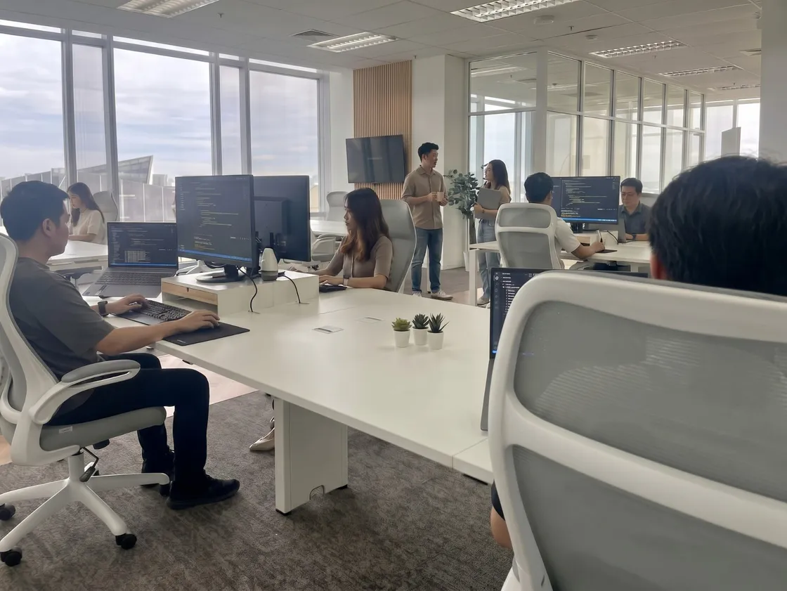 A dedicated offshore team at work in the Azendo office in Bangkok, with the skyline through the windows