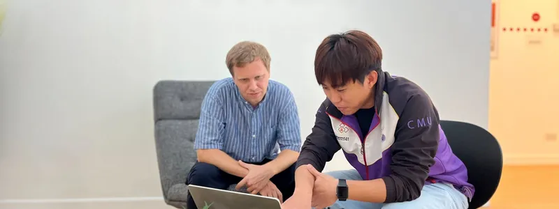 Two offshore software developers doing a code review in the Chiang Mai office