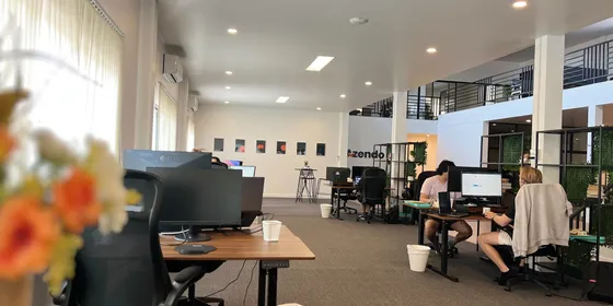 Specialists working at their desks across the open-plan Azendo office floor in Chiang Mai