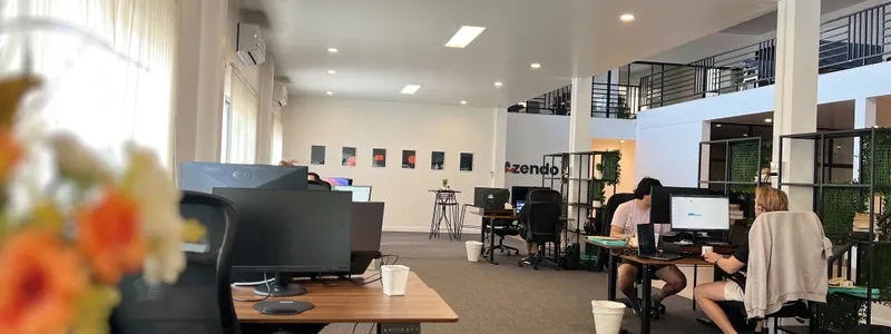 Specialists working at their desks across the open-plan Azendo office floor in Chiang Mai