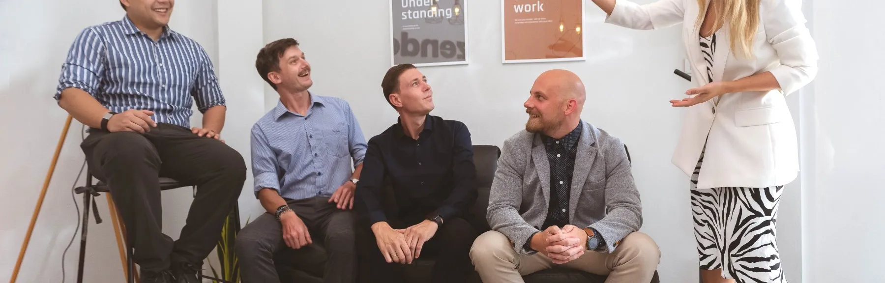 Five Azendo colleagues, including founder Mikkel Schmidt, sharing a laugh in a meeting