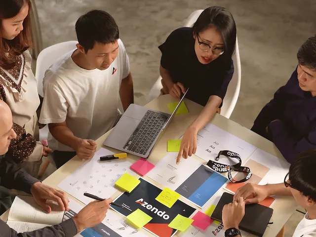 Azendo specialists planning around a table covered in sticky notes and sketches