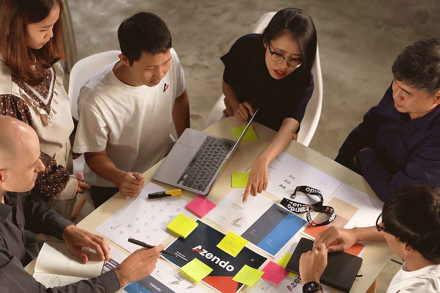 Azendo specialists planning around a table covered in sticky notes and sketches