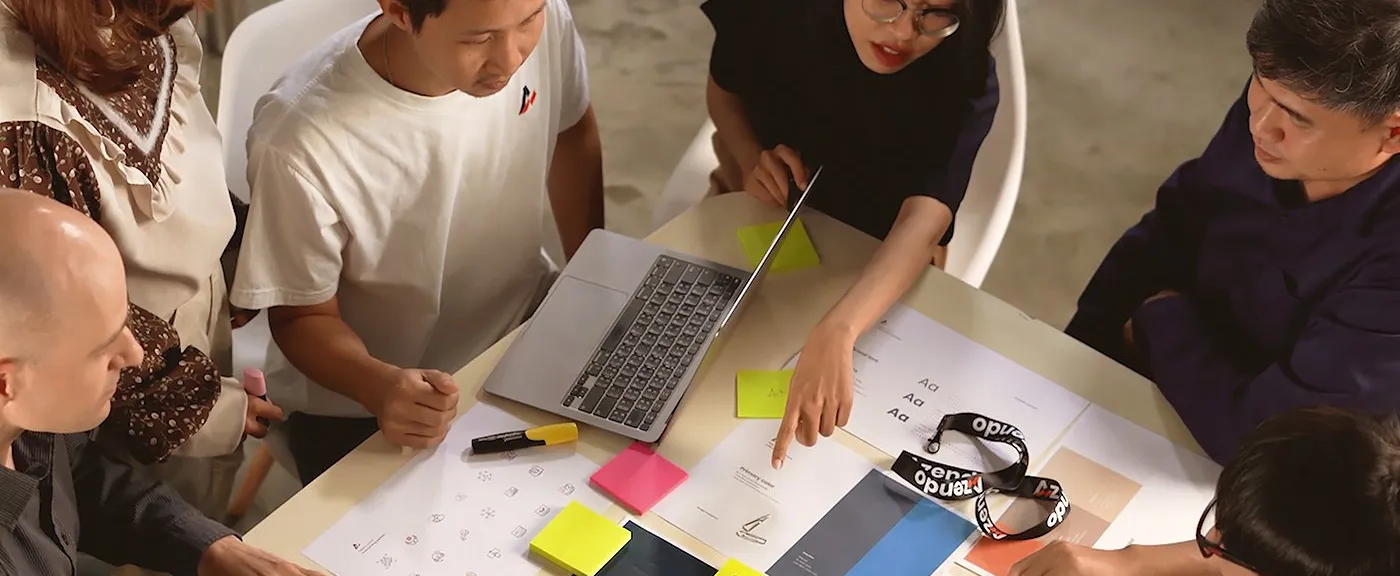 Azendo specialists mapping a manual workflow on sticky notes before building AI automation
