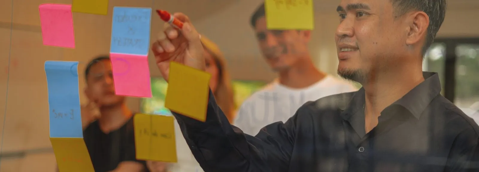 An Azendo specialist planning AI engineering work on sticky notes during a workshop